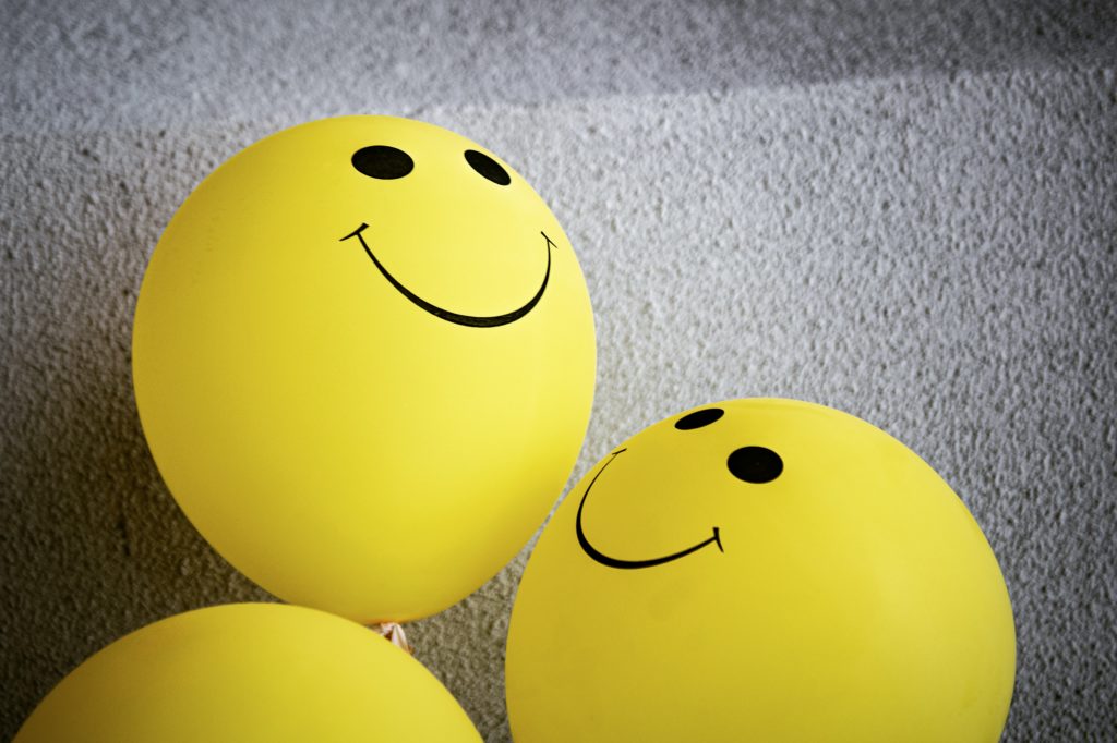 Balloons with smiley faces indicating positivity